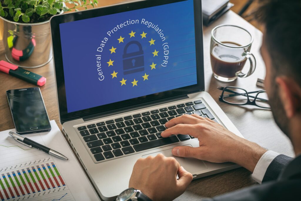 man working with a computer general data protection regulation and european union flag