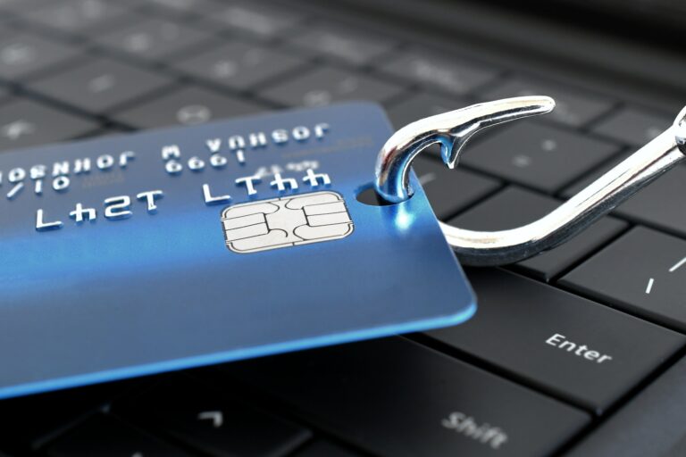 beware of phishing scam emails concept credit card on a fishing hook on computer keyboard